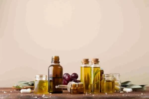 Ensemble de bouteilles en verre remplies d’huiles végétales naturelles sur une table en bois, avec des herbes et des capsules nutritionnelles, illustrant les bienfaits et la diversité des huiles végétales pour la santé.